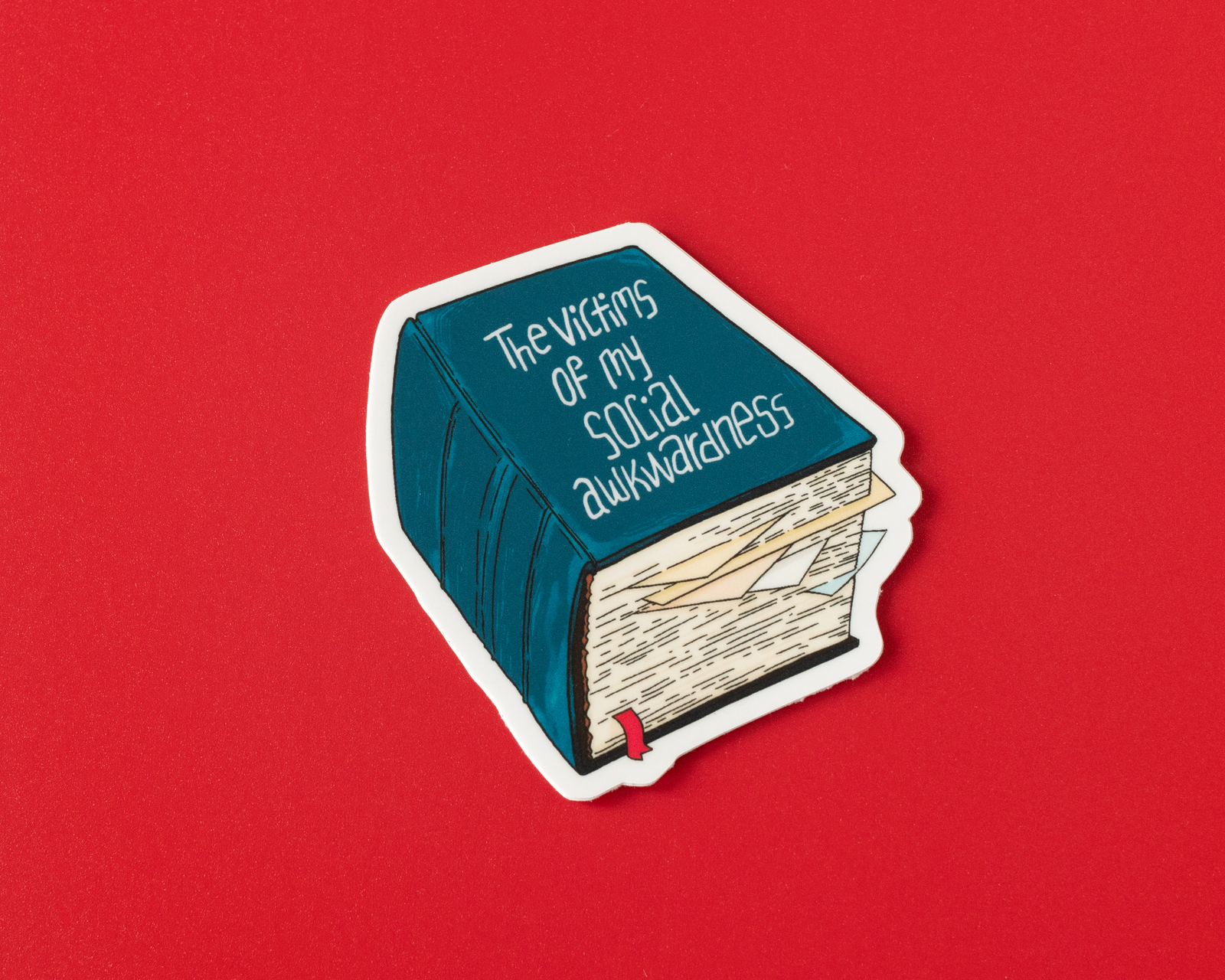 Book-shaped sticker with text on a red background